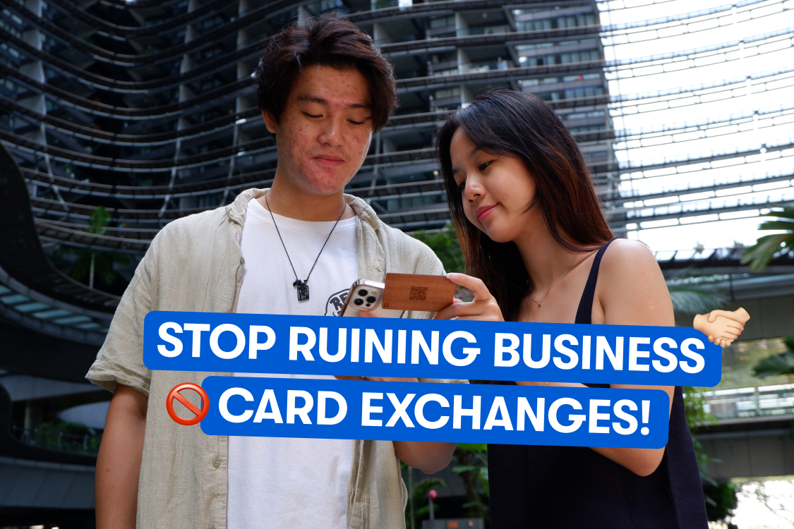 A lady exchanging her business card with a man