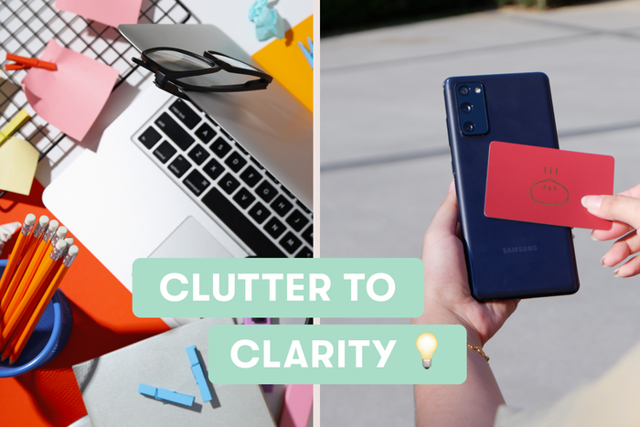 A desk full of stationery and a card tapping on smartphone