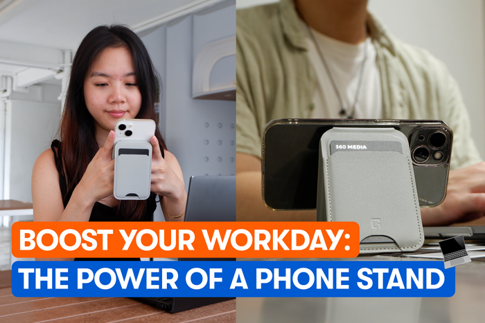 A lady using her phone and a man using a phone stand  at a cafe
