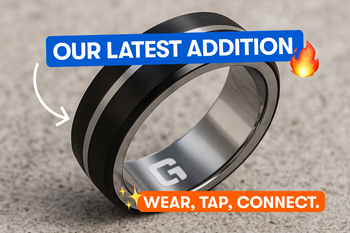 A man wearing a ring and holding a smartphone