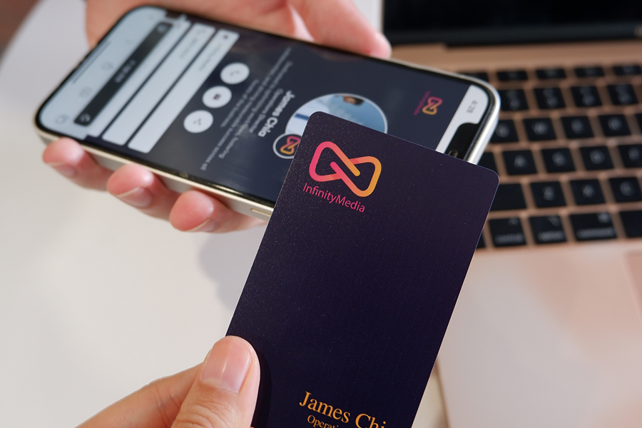 Custom NFC business card designed in company brand colours and shared with a smartphone