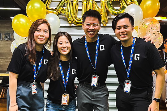 Employees attending a company event with branded corporate gifts and lanyards
