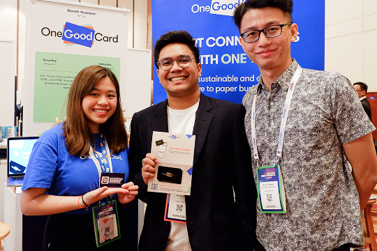 Guests receiving branded corporate door gifts at an event entrance