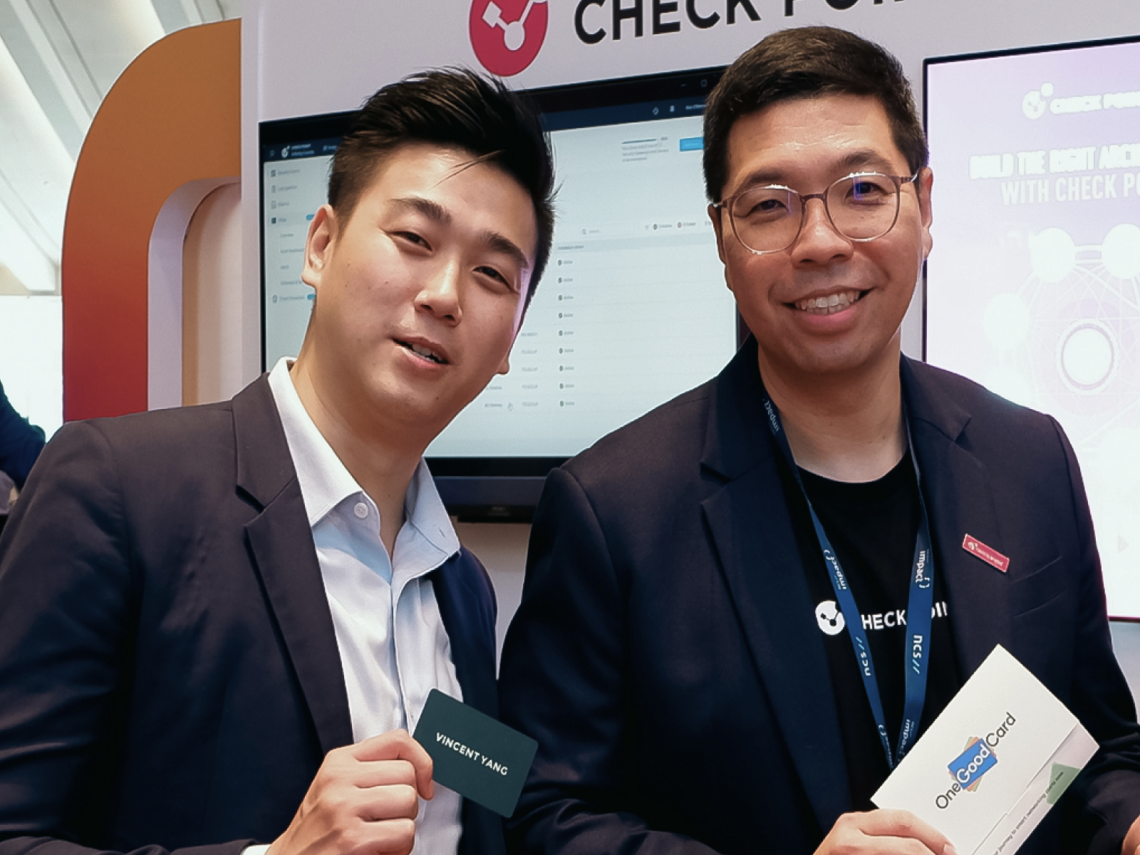 Attendees engaging with a live NFC business card printing booth at a corporate event
