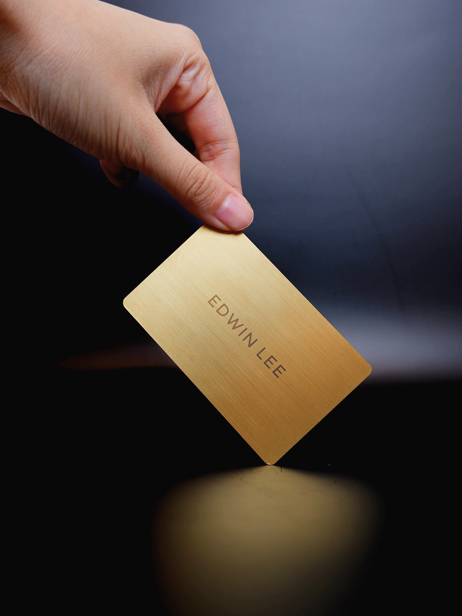 Personalised gold metal NFC business card engraved with an individual name as a premium corporate gift