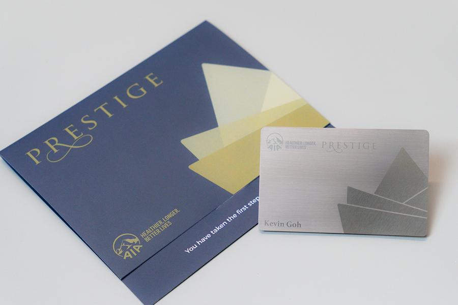 Premium metal NFC business cards presented with a branded Prestige gift sleeve