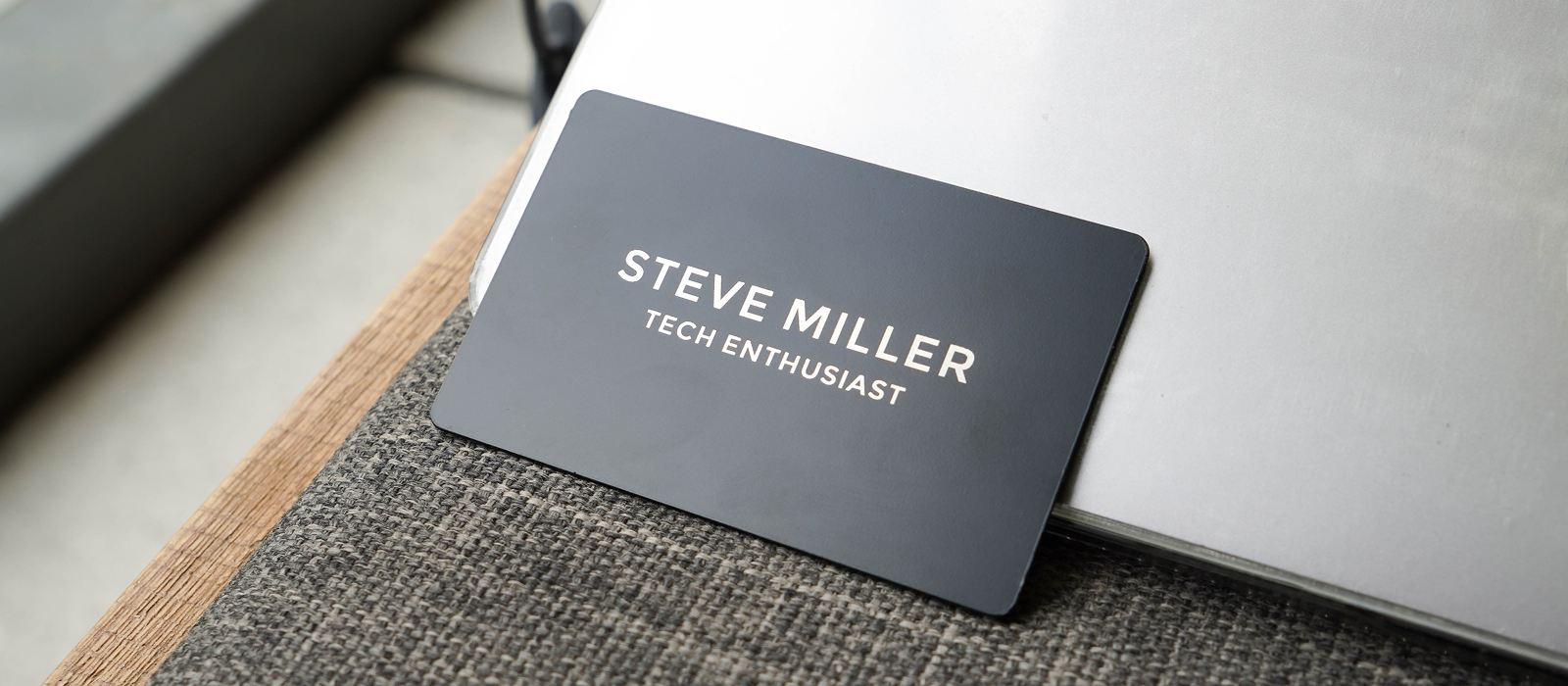 Laser-engraved metal NFC business card customised with a company logo