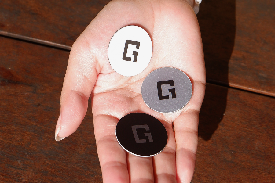 One Good Card Mini NFC stickers displayed in black, white and prism finishes